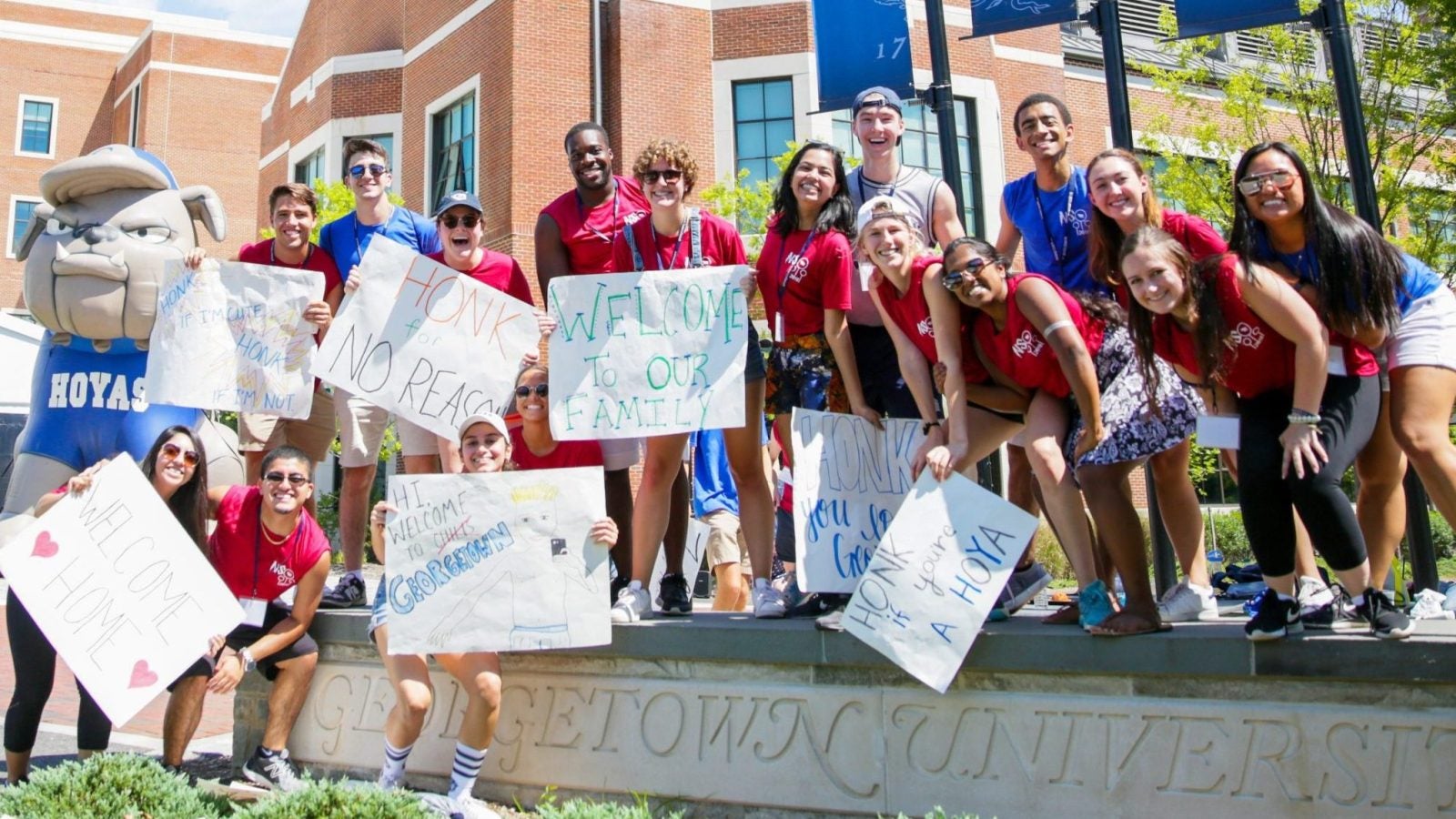 Group of students with welcoming signs