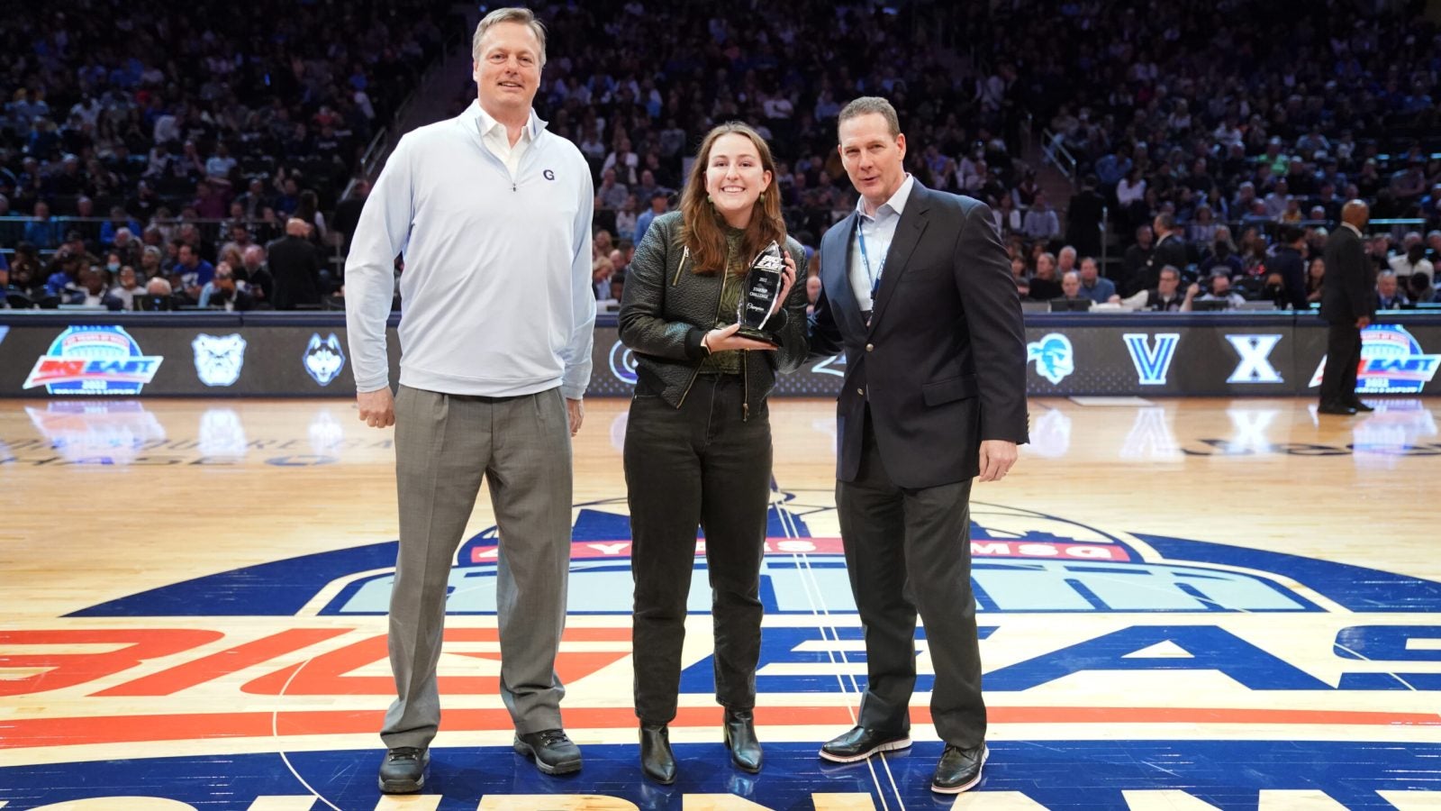 Gracey Owen, a Business School student, receives the Big East Startup Challenge trophy.