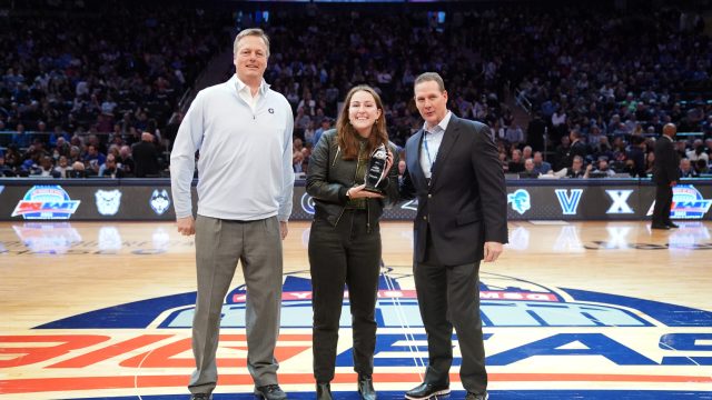 Gracey Owen, a Business School student, receives the Big East Startup Challenge trophy.