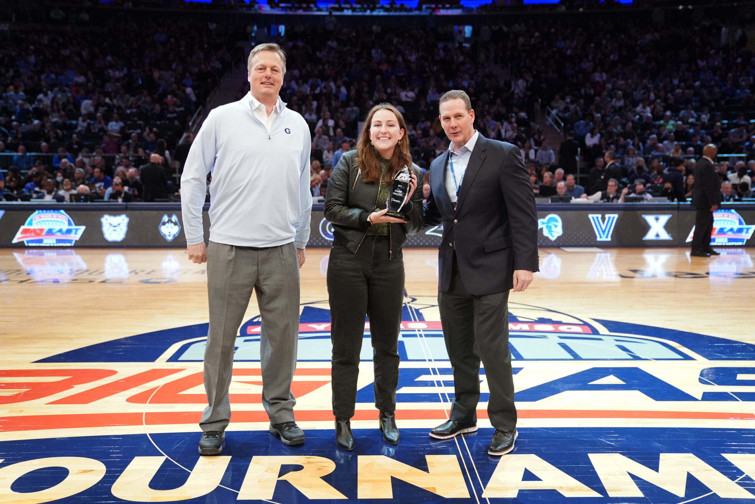 Gracey Owen, a Business School student, receives the Big East Startup Challenge trophy.