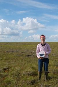 Bridget Power (C'12) pictured in a field in Alaska.