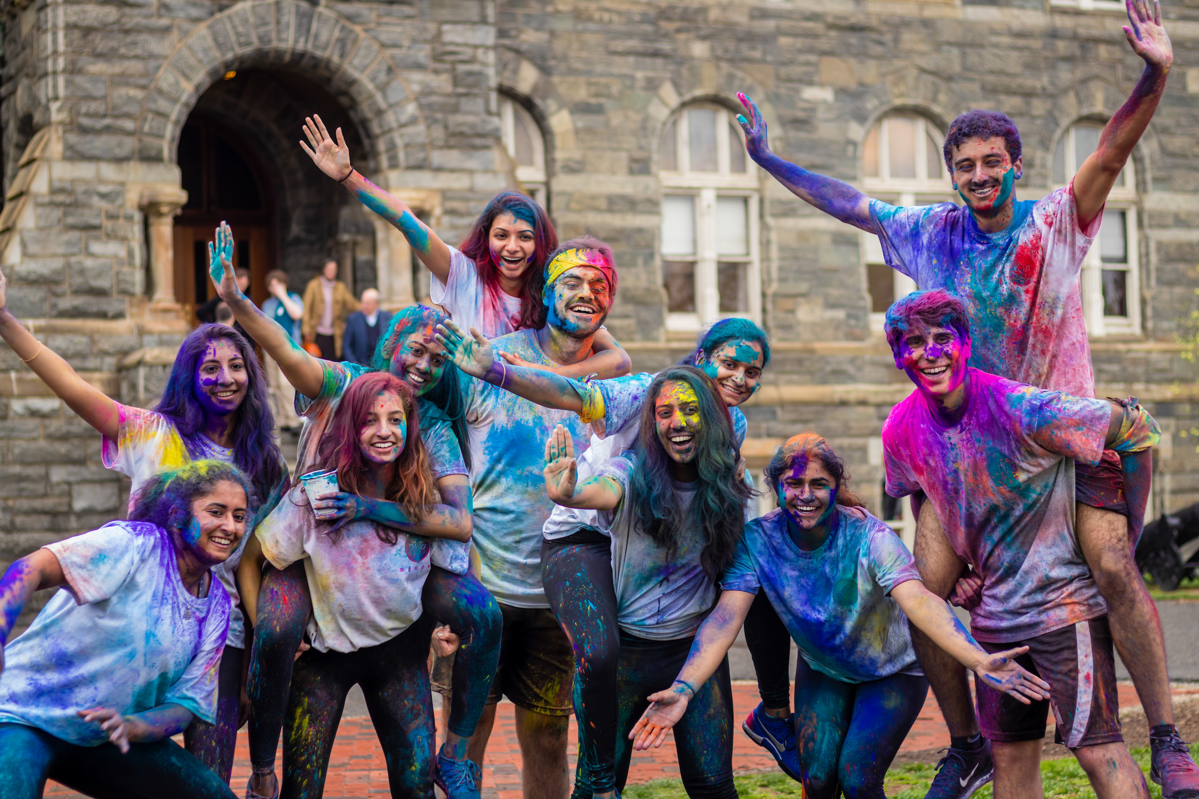 Students covered in multicolor dry paint