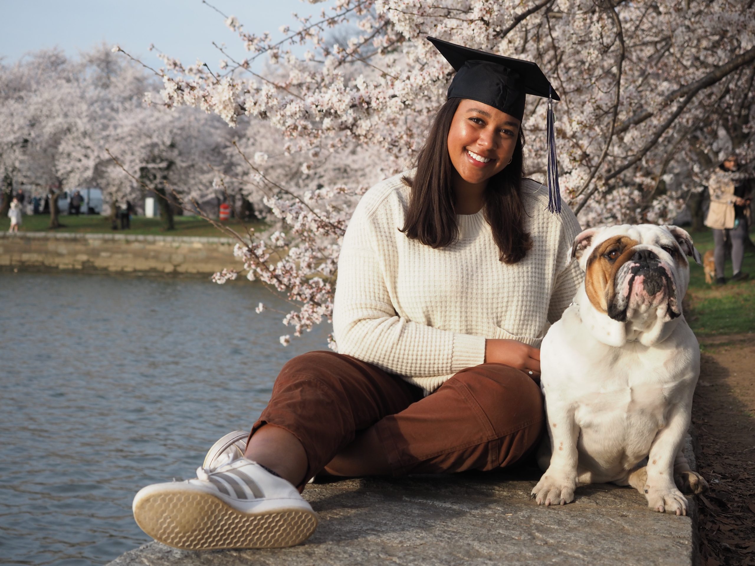 Maya with a graduation cap and Jack the Bulldog