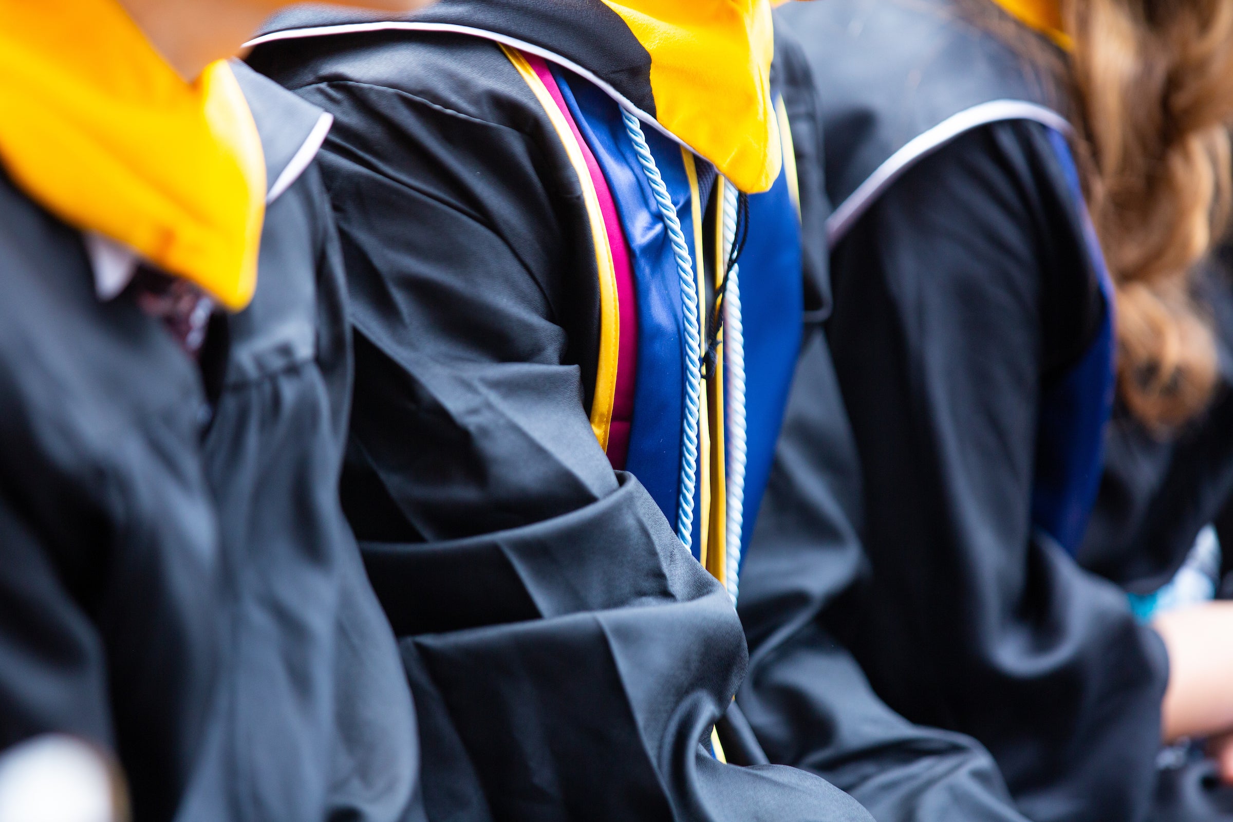 Close-up shot of graduating students academic regalia