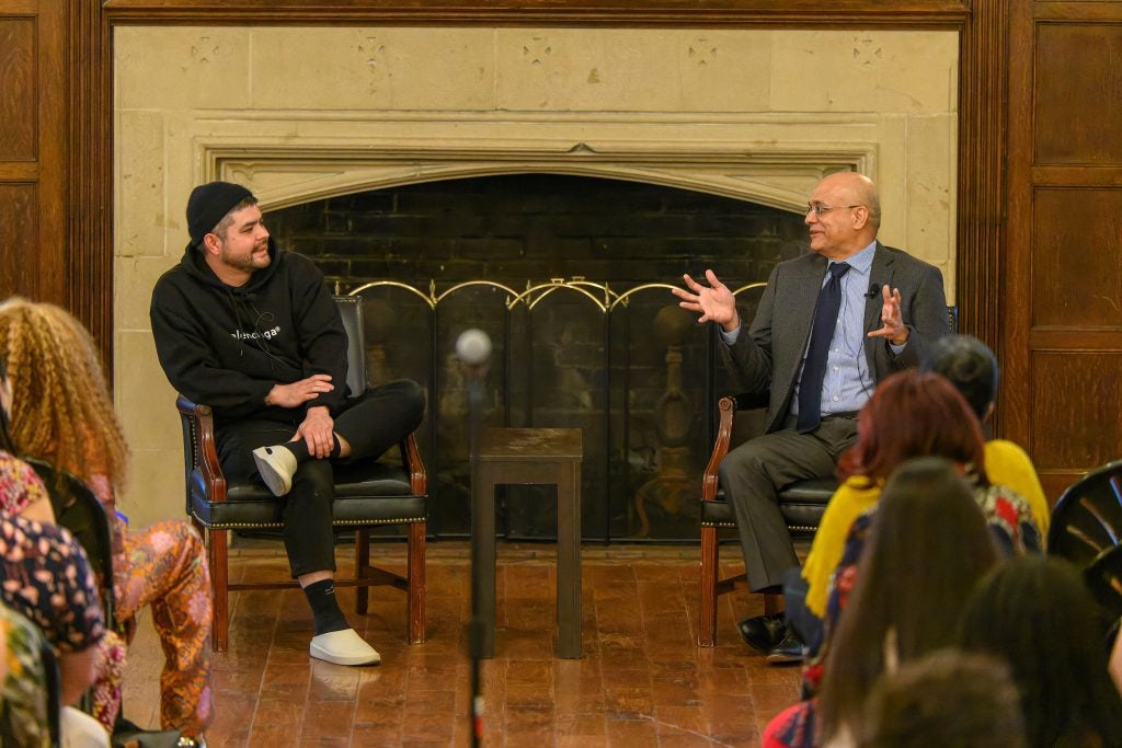 Erik Bruner-Yang talks to Dean Paul Almeida in front of a crowd