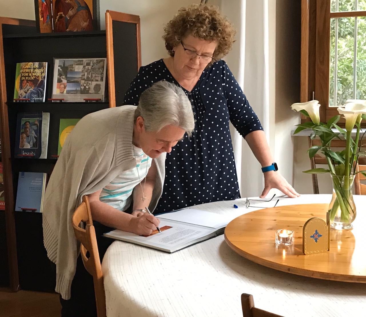 Corscadden inside with another woman bending over a table