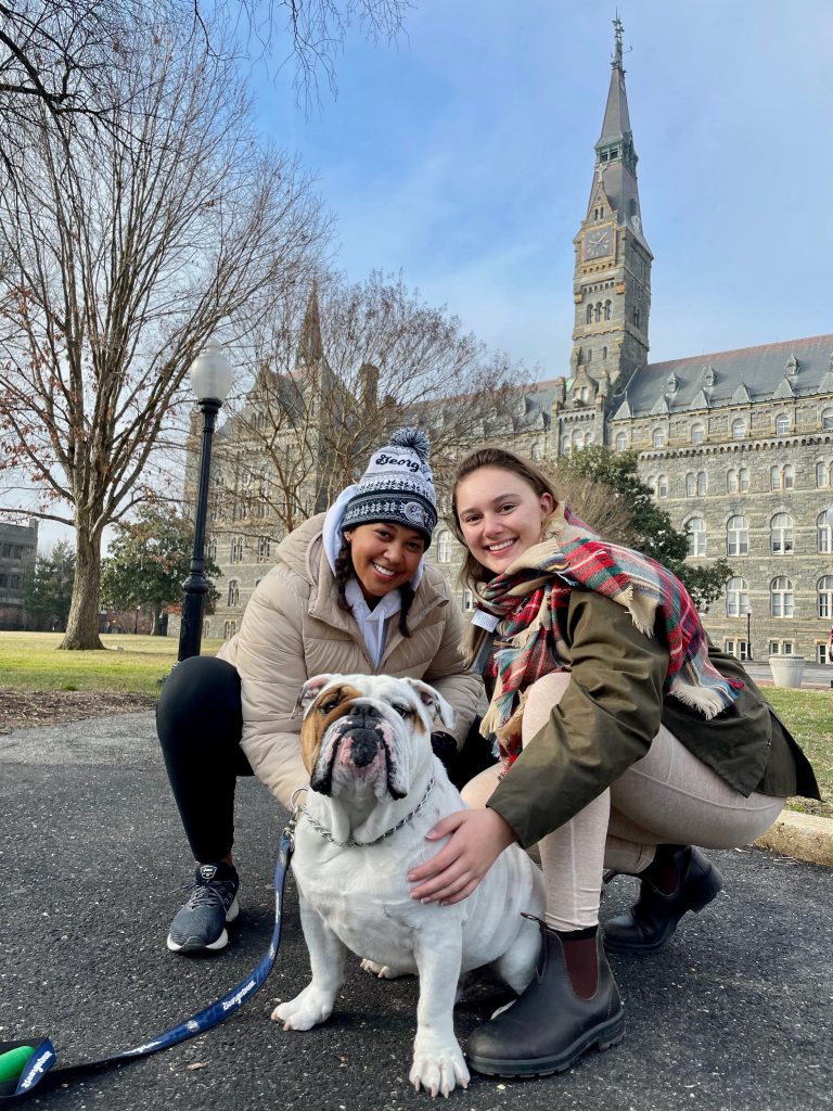 Maya and Amelia with Jack in front of Healy Hall
