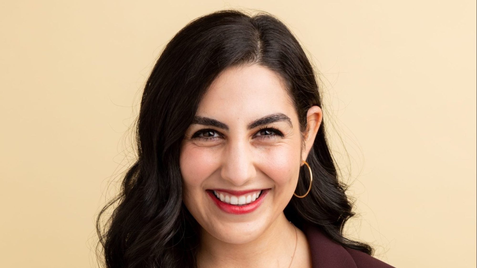 Headshot of Ariana Lily Nikmanesh wearing hoop earrings