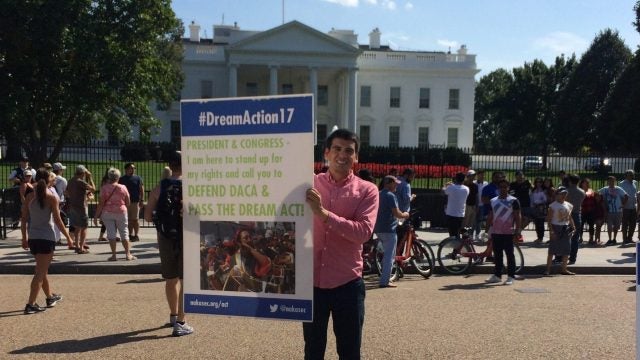 Abel Cruz Flores Holds a Dream Act sign in front of the White House