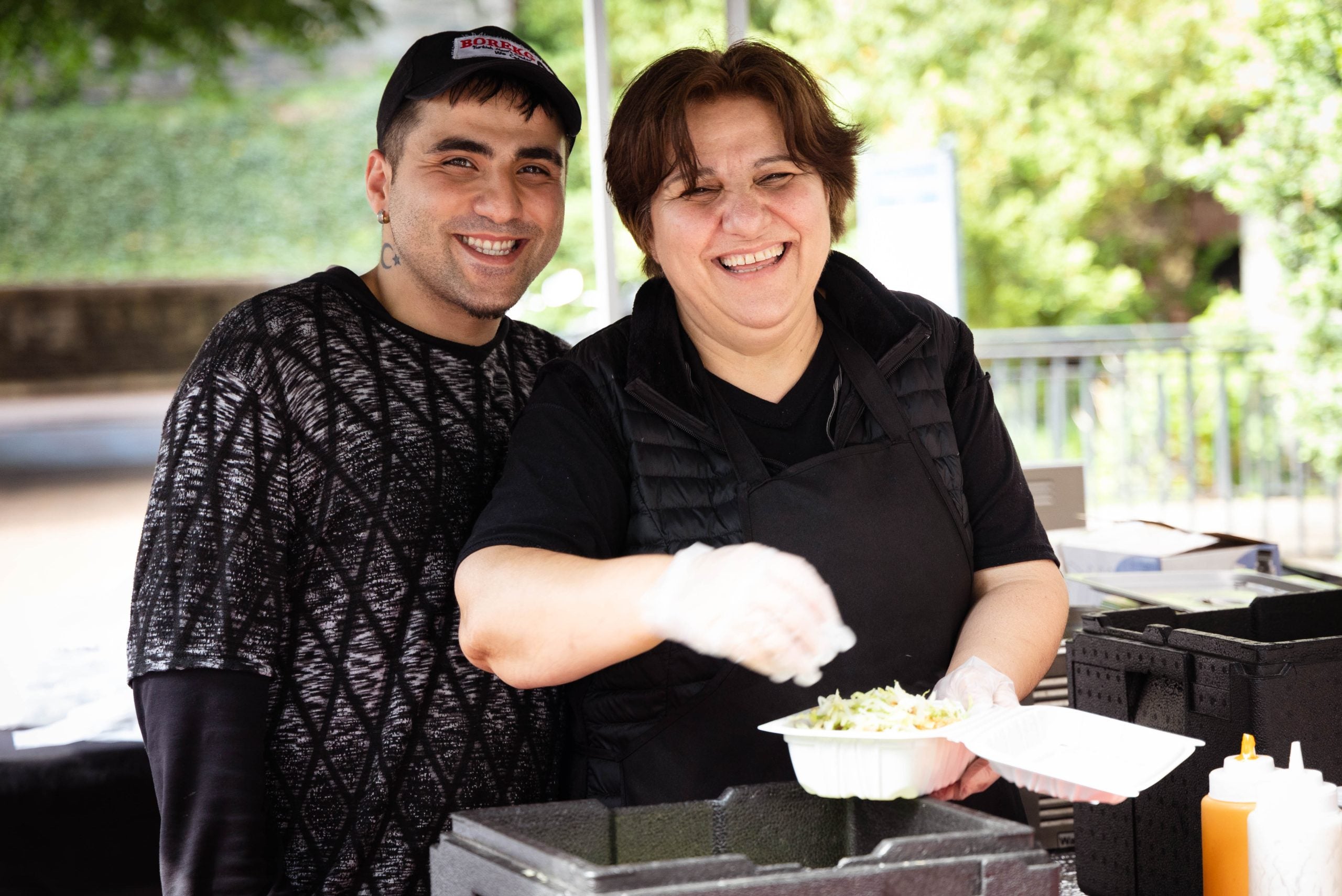 An image of a mother and son at their stall at the Georgetown farmers market. 