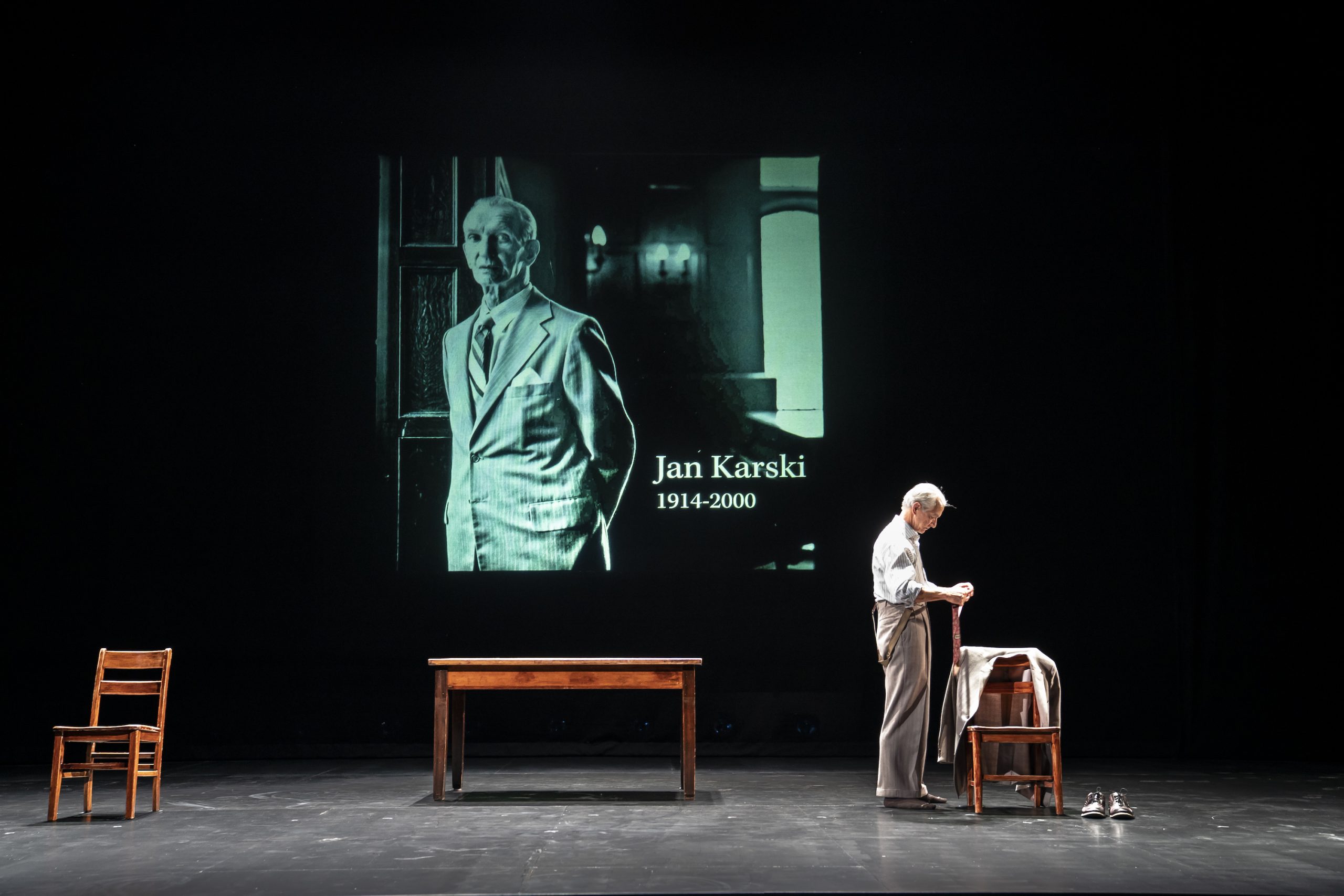 Stathairn as Karski stands in front of a projection of the real Jan Karski
