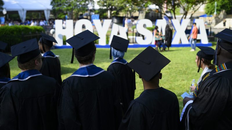 Georgetown students gather in front of the &quot;Hoya Saxa&quot; sign on Healy Lawn