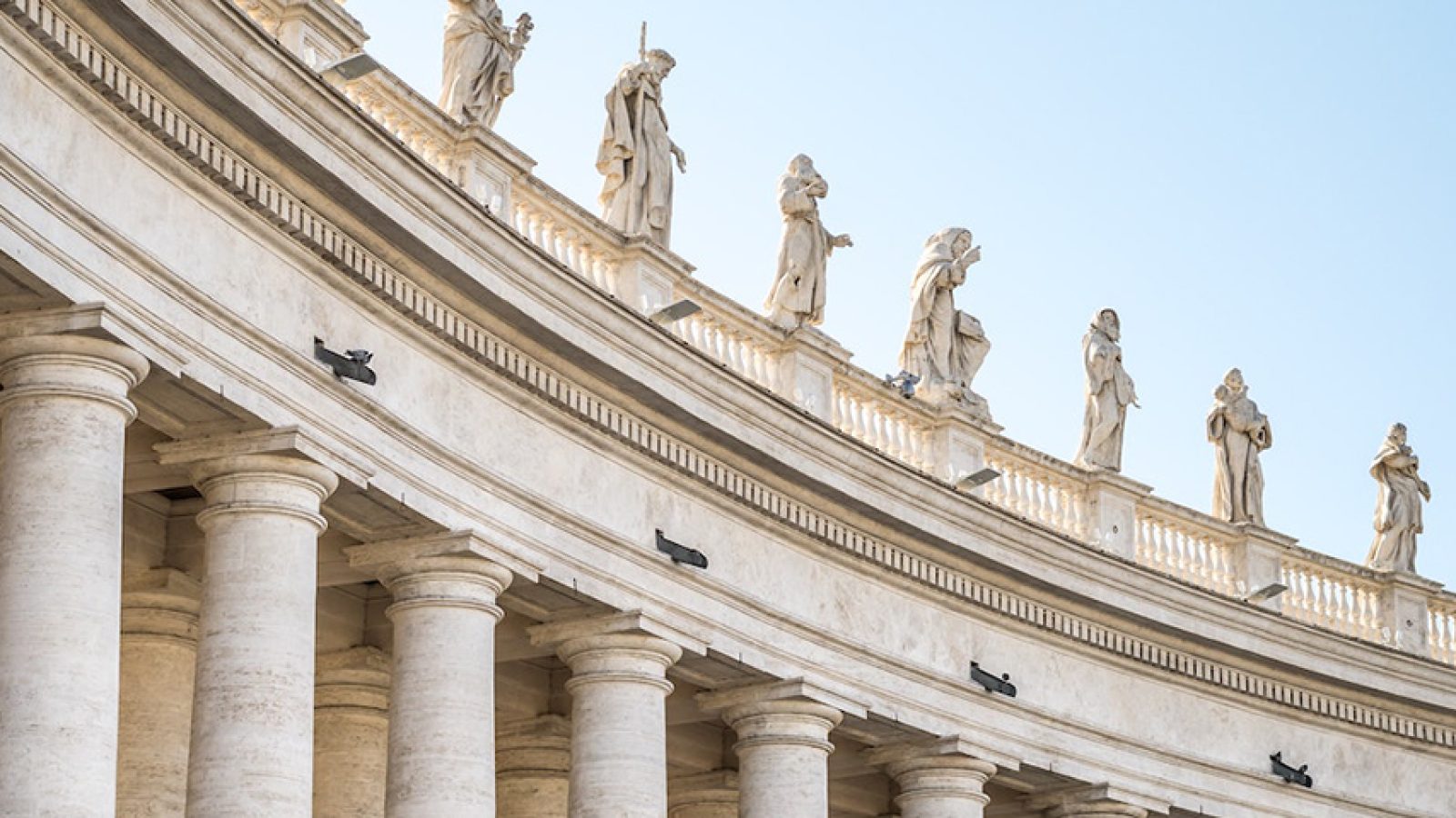 An image of white columns at the Vatican in Rome