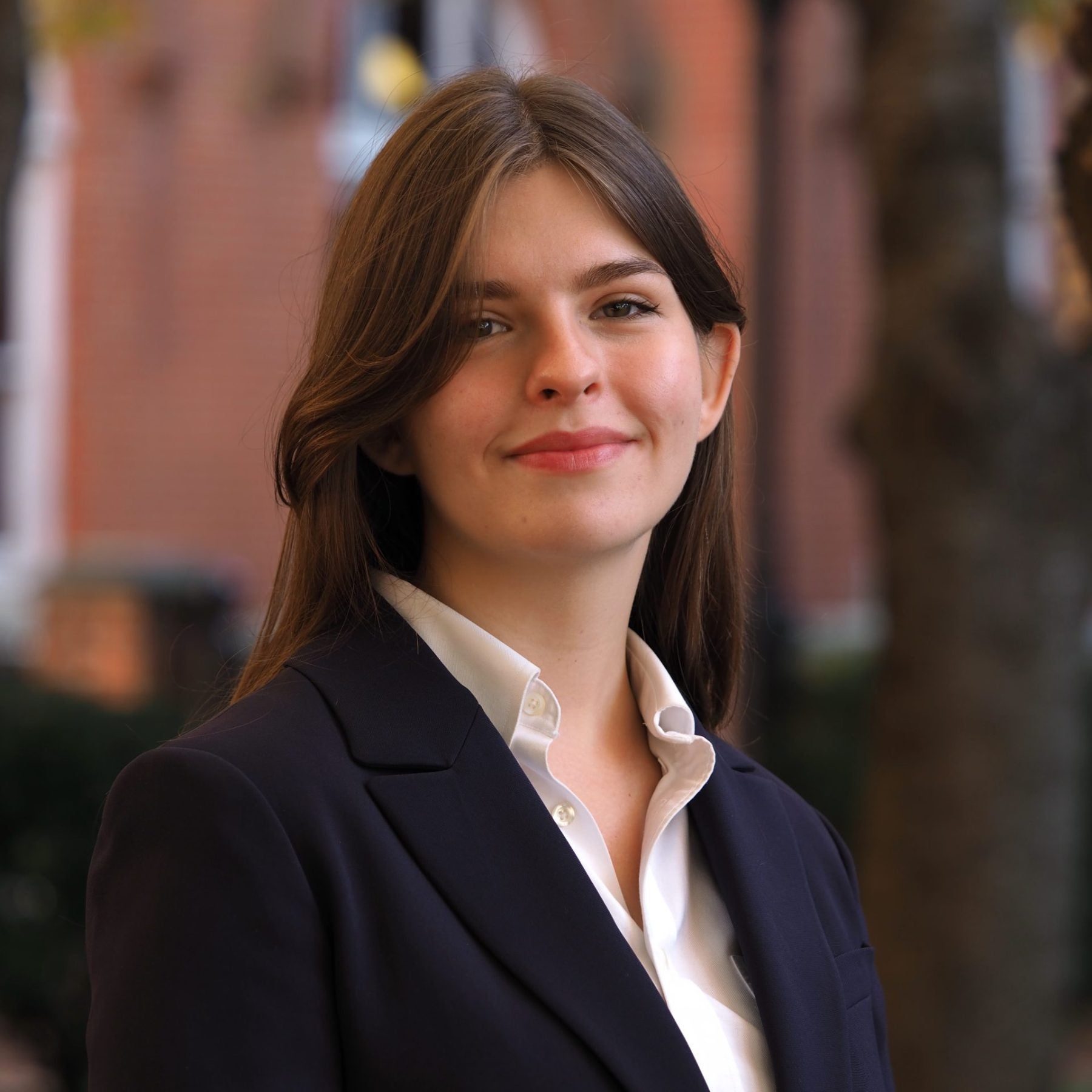 Headshot of Elena Sapelyuk wearing a blazer and white button-down top in Dahlgren Quad