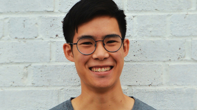 An image of Phil Wong, an alumnus and creator of a food startup, wearing a gray T-shirt and glasses.