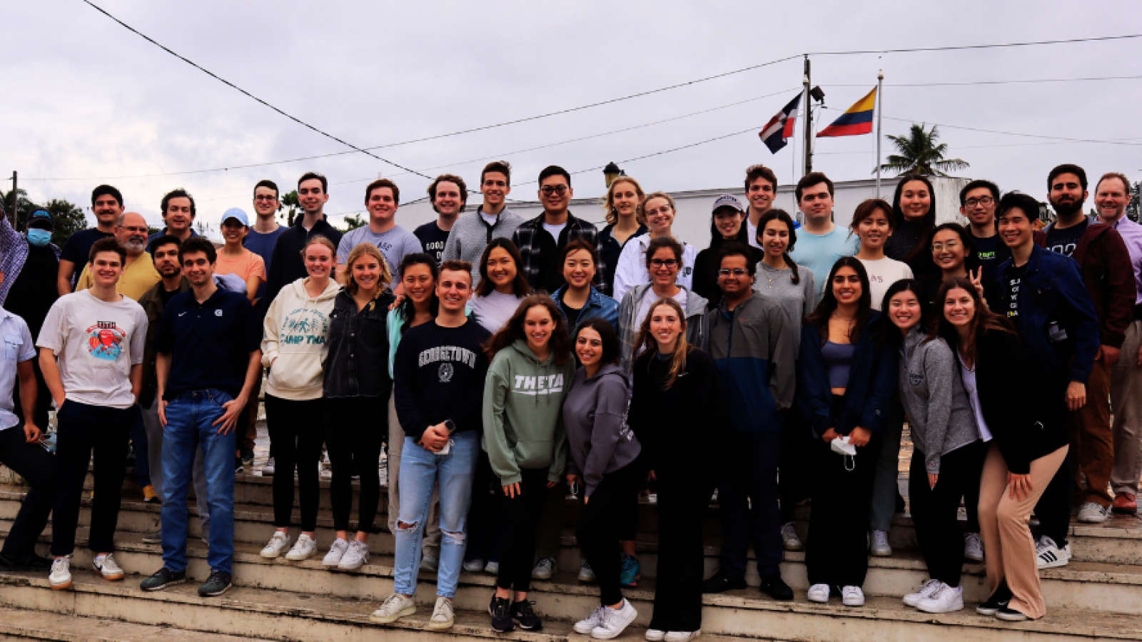 A large group of students from the Bachelor of Science in Business and Global Affairs program pose together during an immersion trip in the Dominican Republic.