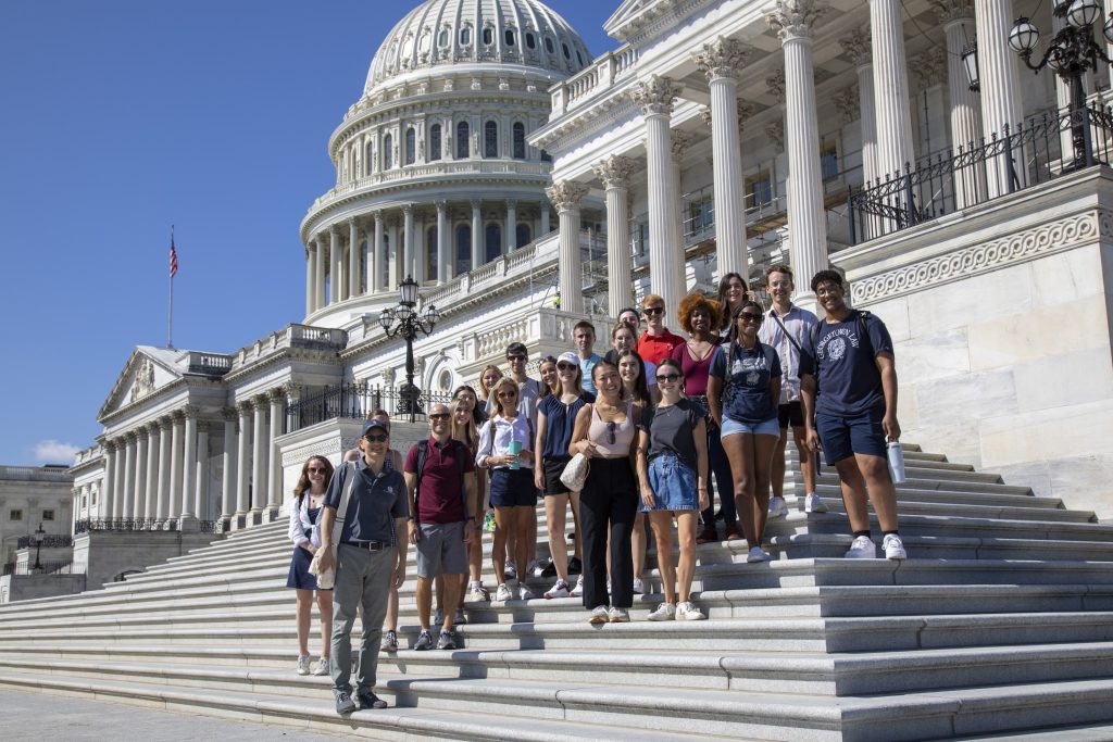 Students stand in a group in front of the Capitol Building