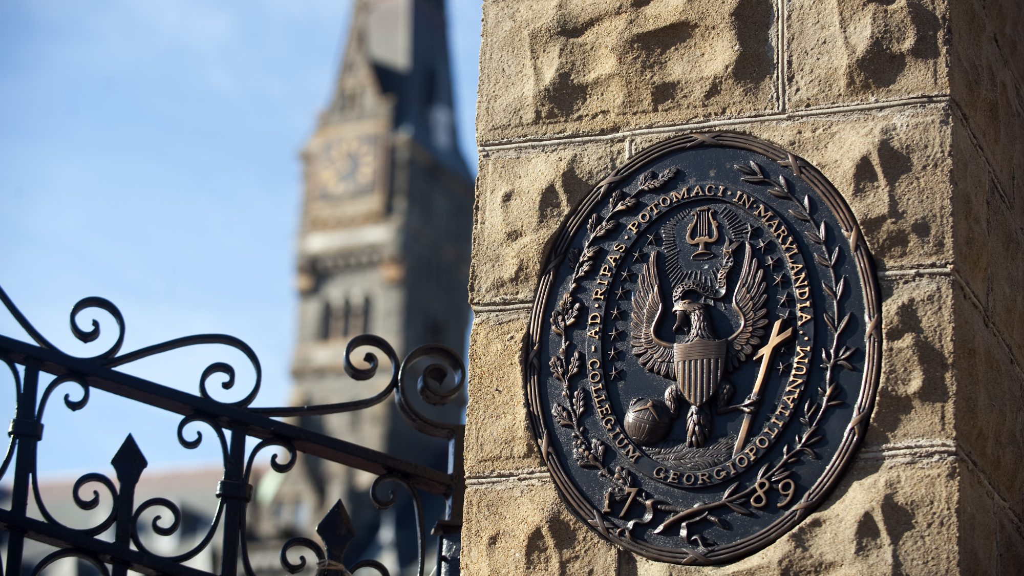 An image of Georgetown's seal on a pillar at the gates of the university's campus.