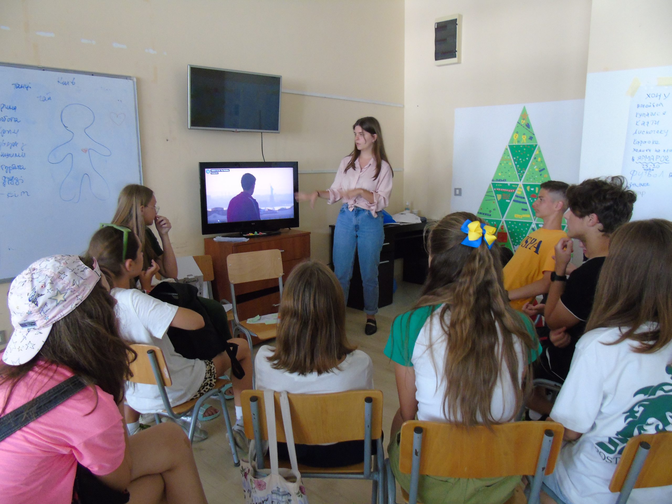 Elena Sapelyuk (SFS'23) teaches creative writing to a group of students facing her in a classroom during a summer camp in Montenegro.