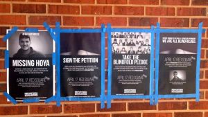 Posters on a brick wall taped up with blue tape about bringing home Austin Tice