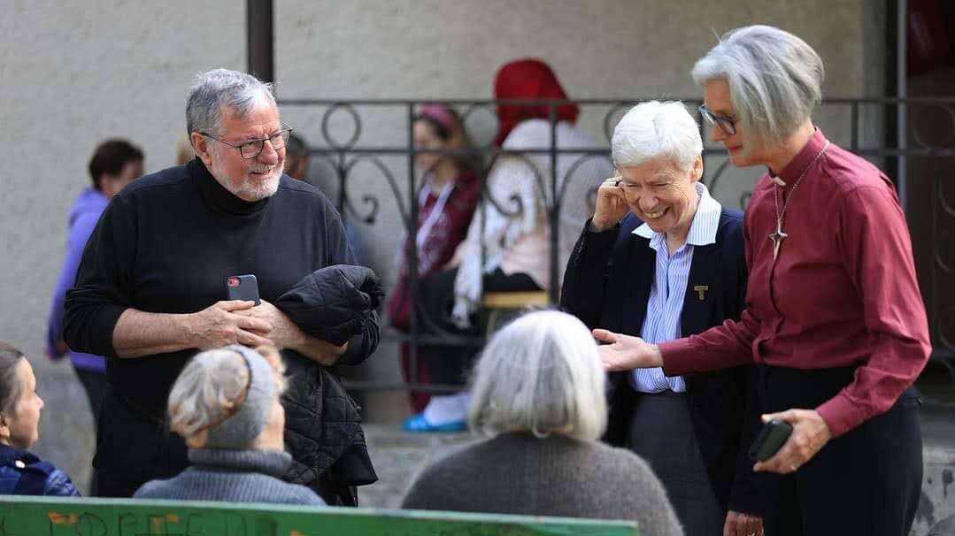 A Georgetown professor listens and laughs with a group of Ukrainians in Kyiv