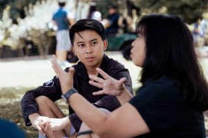 Wyatt Nako (C'26) listens to his mother speak on the lawn outside Healy Hall during move-in 2022.