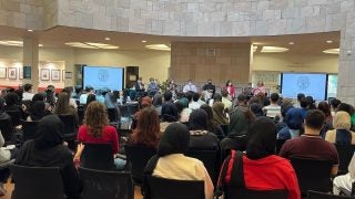 Students watch a panel during orientation