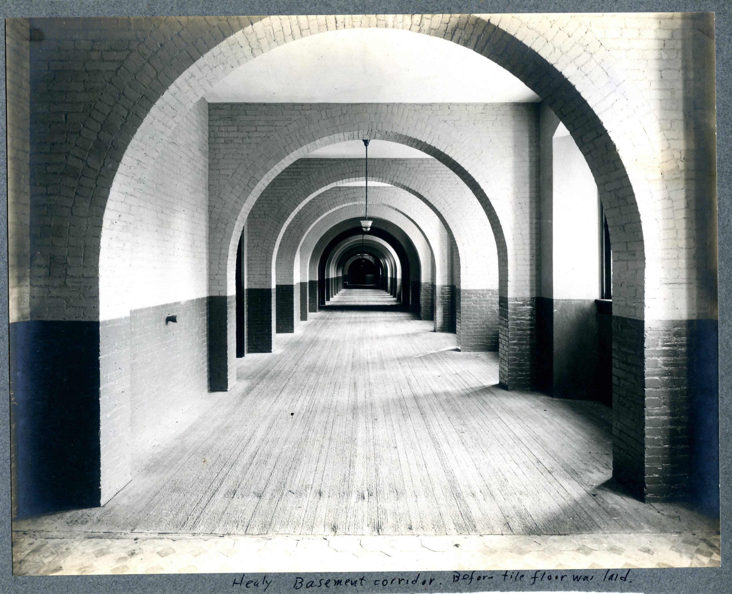 An undated image of Healy Hall basement showing a long corridor with repeating archways.