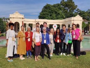 Kate Barranco stands with her small group outside on the lawn during the Wellbeing Project Summit in Bilbao, Spain.