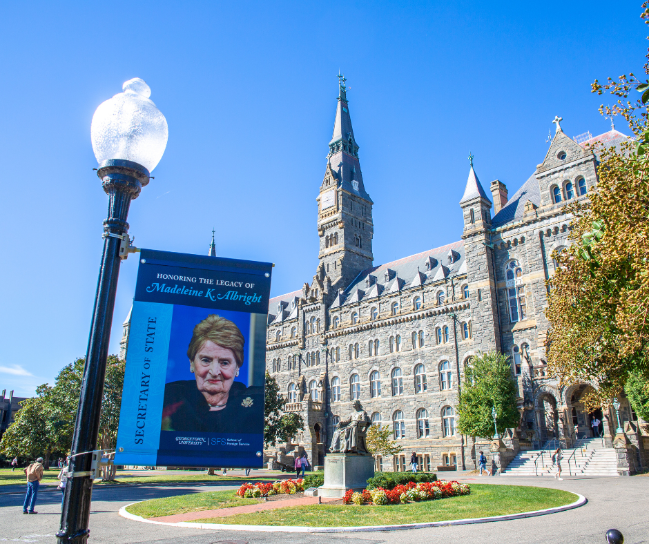 Banner hanging from a lamp post in front of Healy Hall with a photo of Alright and the text "Secretary of State" along the left side