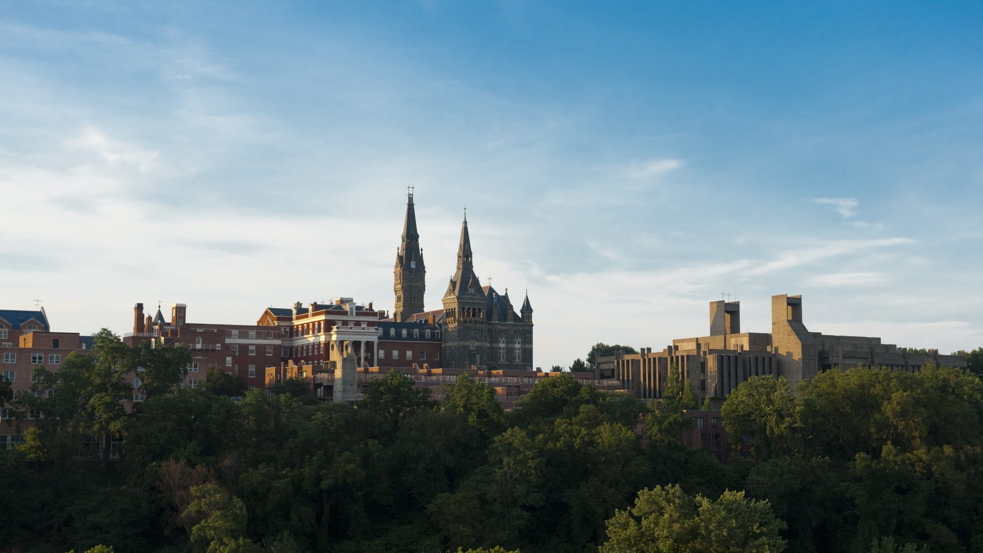 An aerial shot of Georgetown&#039;s campus, centered on the tall spires of Georgetown&#039;s Healy Hall.