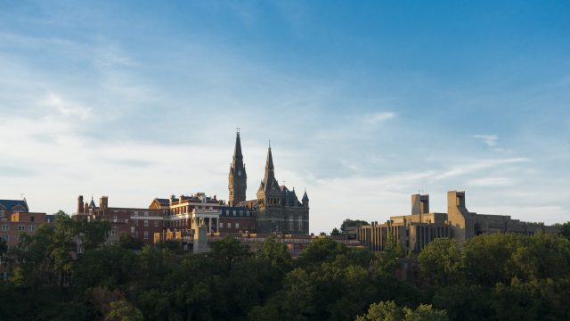 An aerial shot of Georgetown&#039;s campus, centered on the tall spires of Georgetown&#039;s Healy Hall.