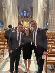 Darren Hall (MSFS’22, MBA’22), Vanessa Jarnes (MSFS’23, MBA’23) and Christopher Mohr (MSFS’24, L’24) pose together at Madeleine Albright's funeral service at the National Cathedral in April 2022.