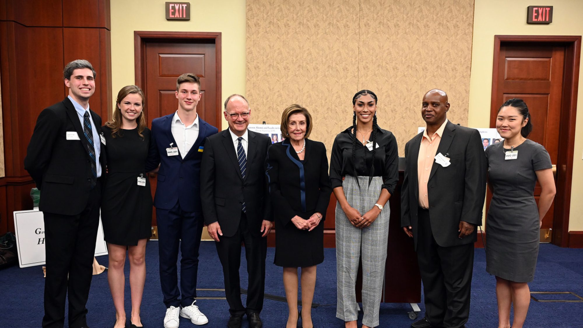 Georgetown students stand with Nancy Pelosi and Georgetown President John J. DeGioia