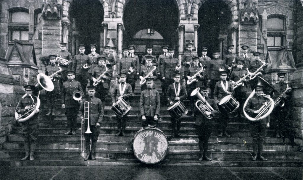 The Georgetown Pep Band stands on the steps of Healy Hall in 1926 with their instruments, just four years after the band was estsablished.