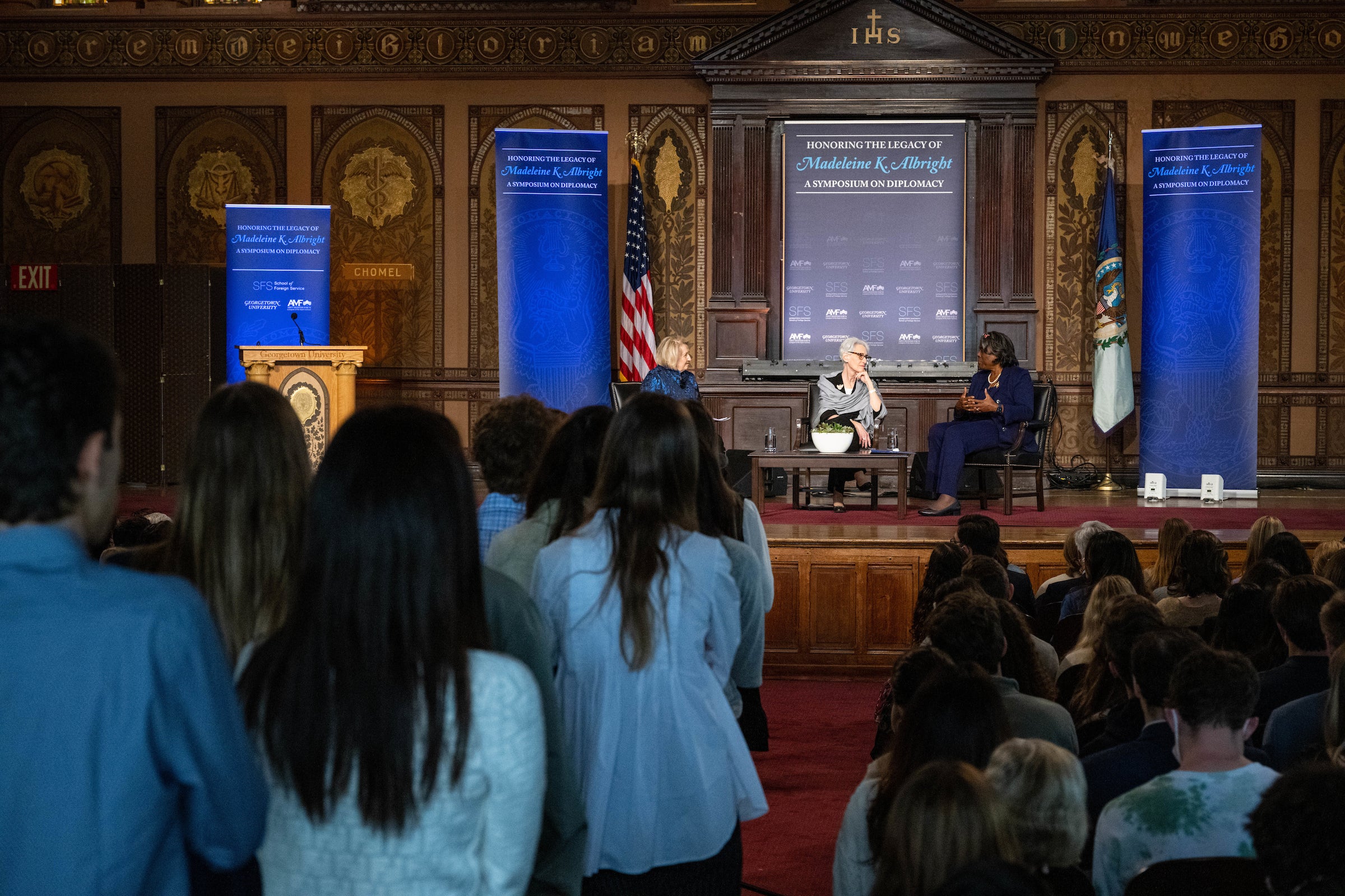 Students line up in a middle aisle in front of the stage