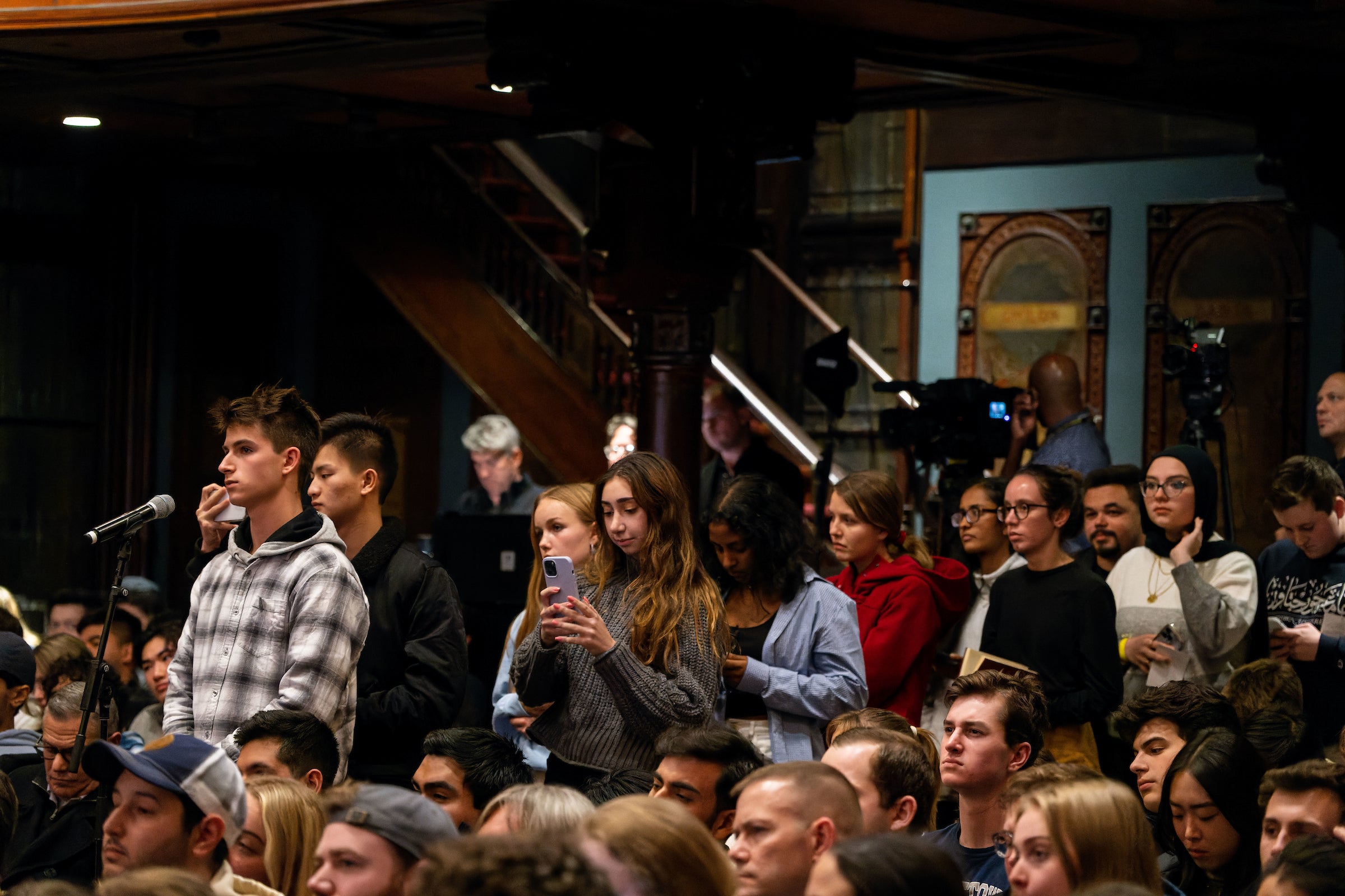 Students wait in line in Gaston Hall to ask questions