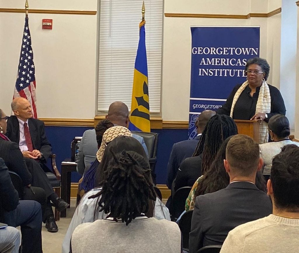 Mia Amor Mottley speaks from behind a podium as a small audience watches