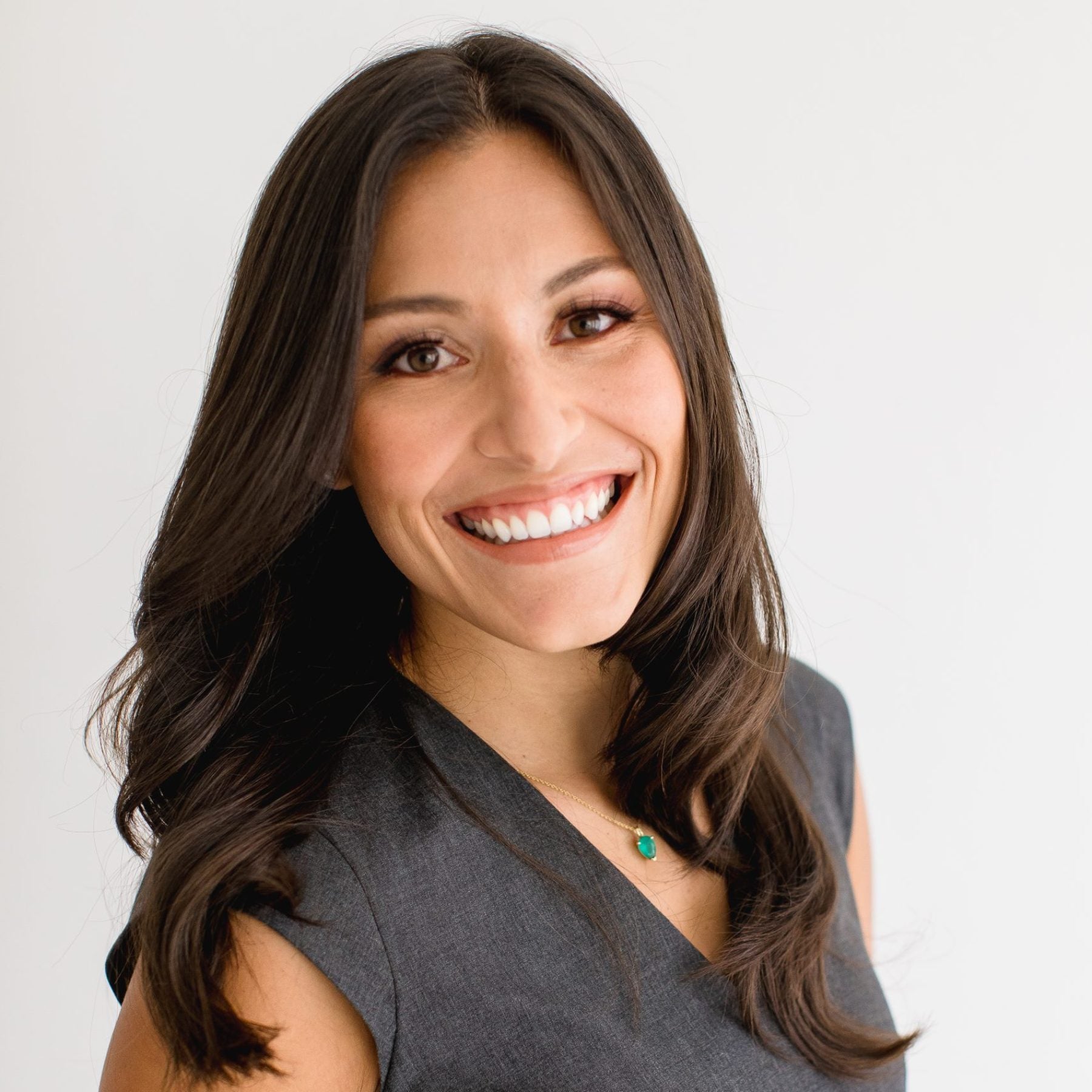 Headshot of Tahina Montoya wearing a gray dress