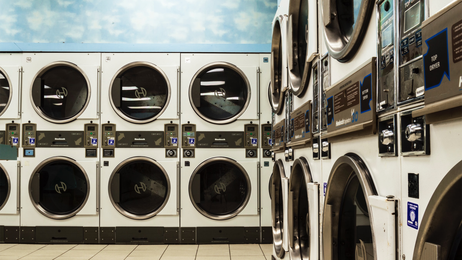 Washing machines stacked in two rows in a laundromat