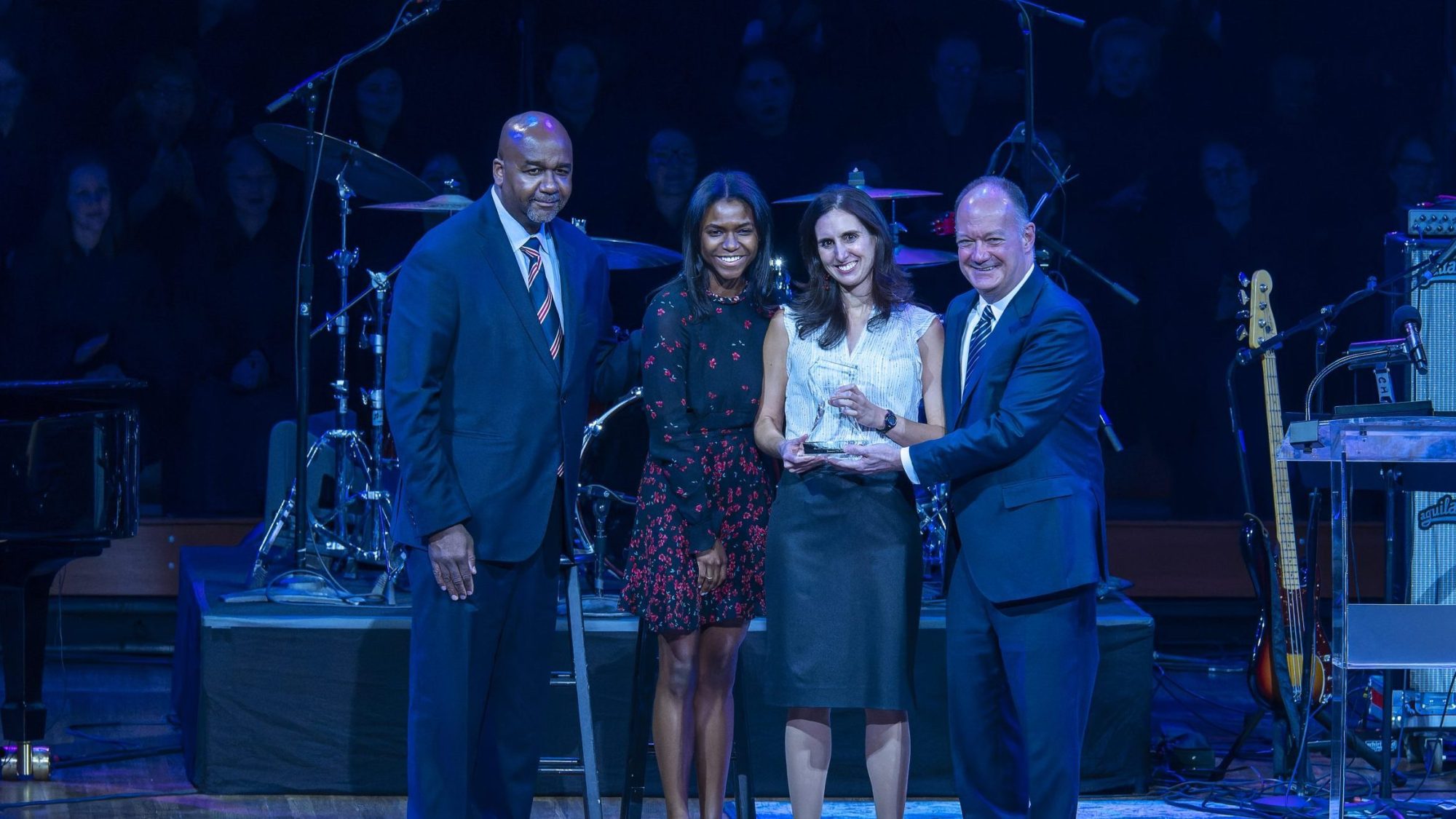 Paula Fitzgerald, recipient of the 2023 John Thompson Jr. Legacy of a Dream Award, stands with Georgetown President John J. DeGioia and two members of the late Coach Thompson&#039;s family at a reception event.