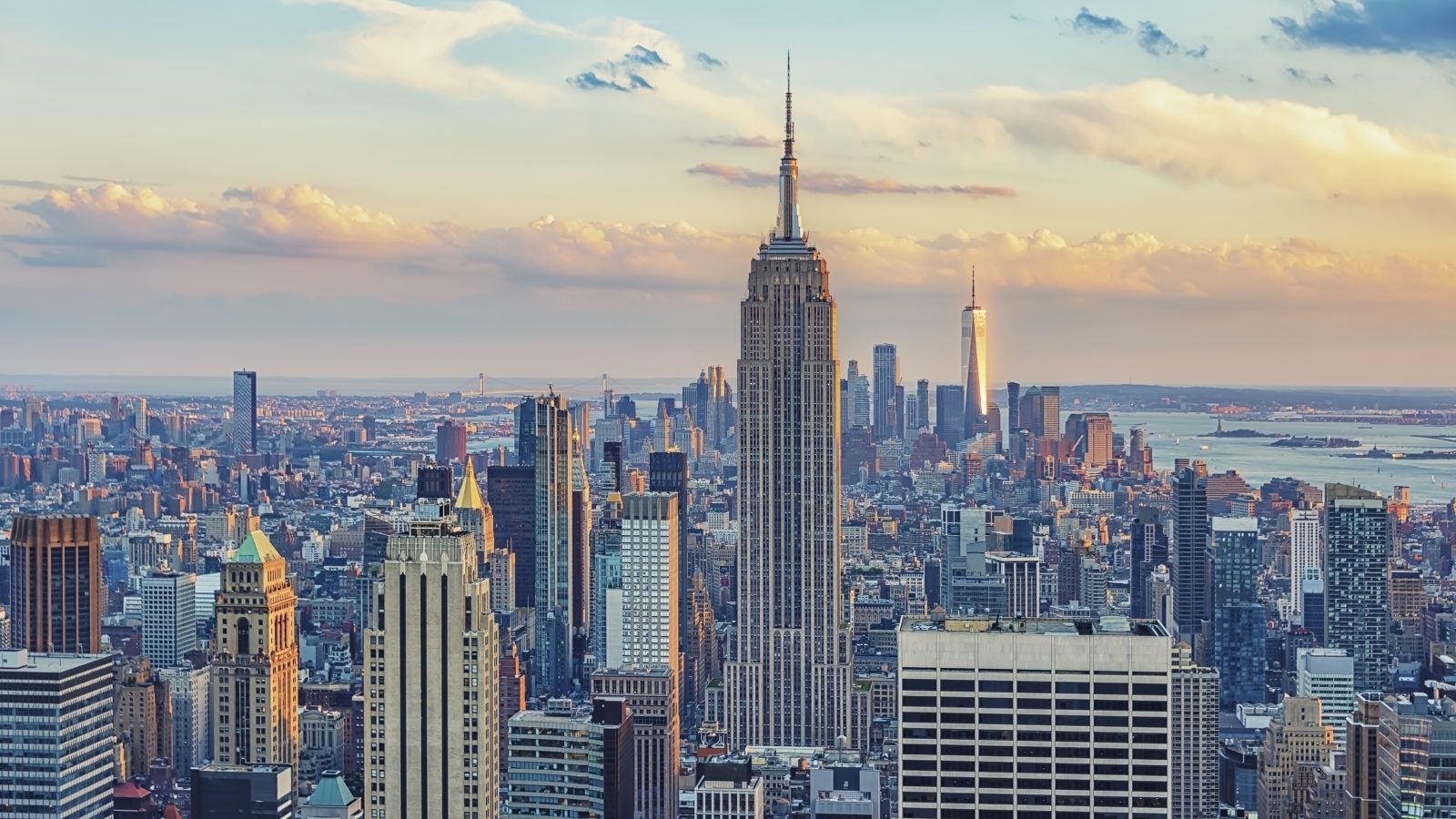 An image of the New York City skyline against a pink and blue sky.