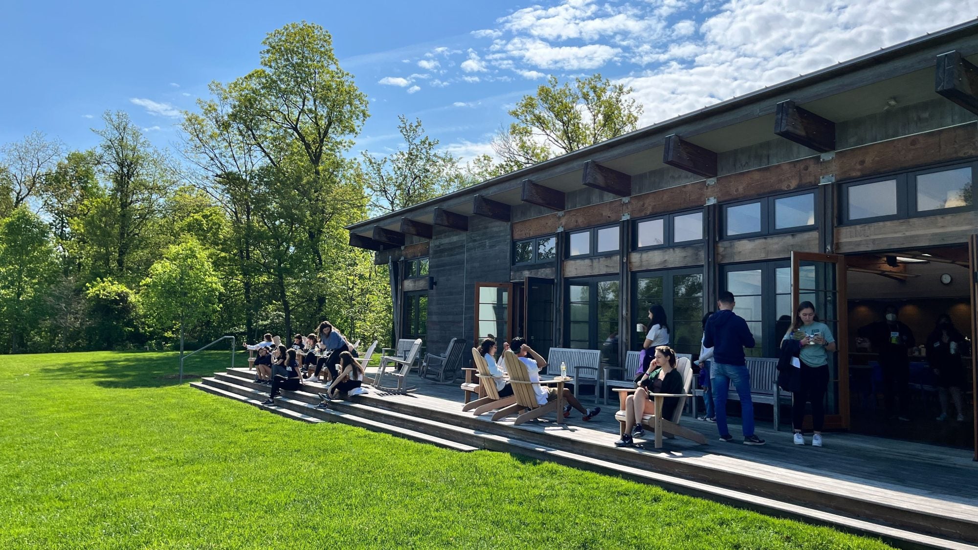 Individuals sitting outside on a sunny day at the Calcagnini Center.