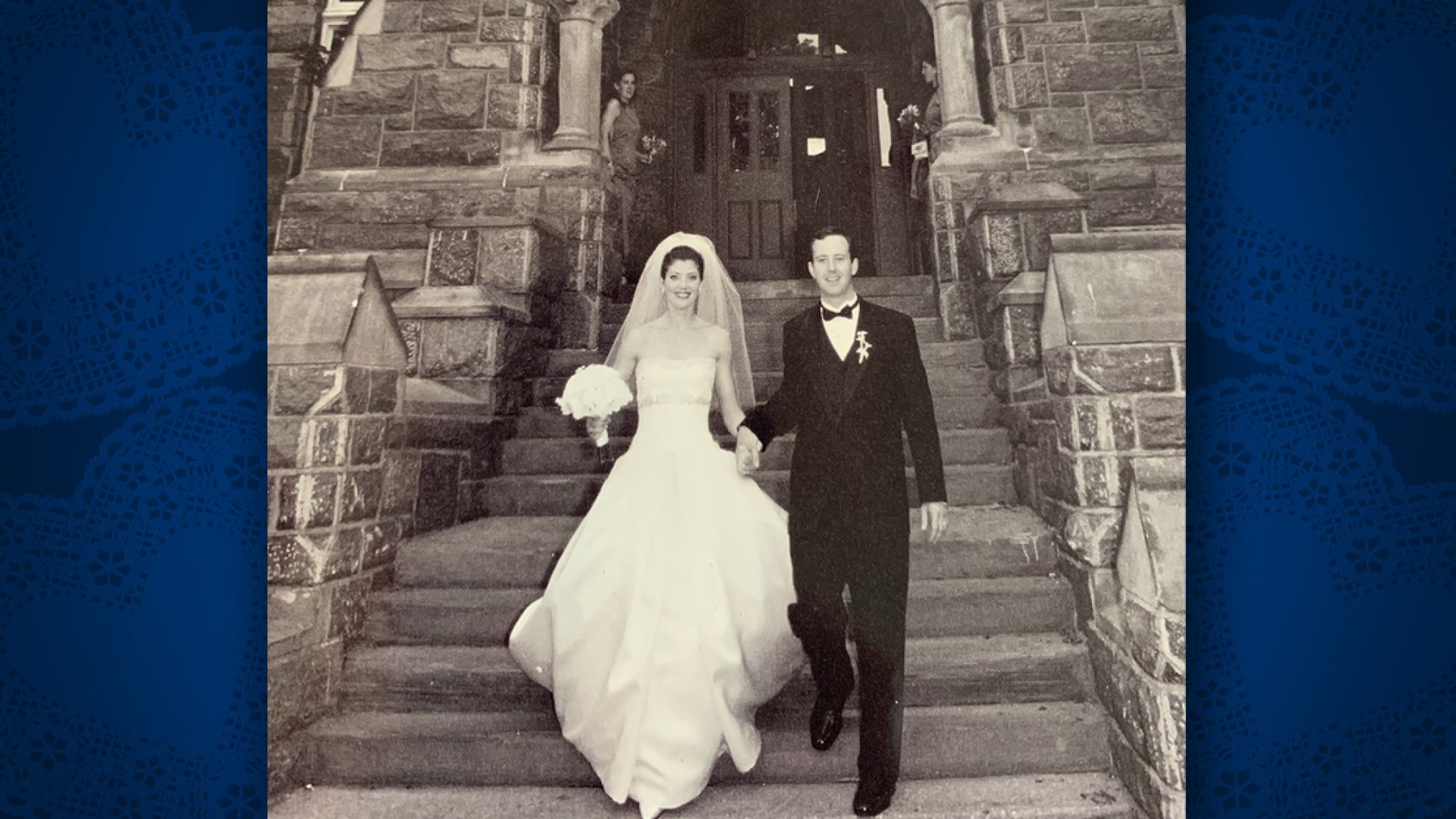 Black and white photo of Norah O&#039;Donnell (C&#039;95, G&#039;03) wearing a wedding dress and Geoff Tracy (C&#039;95) in a tuxedo on the steps of Healy Hall.