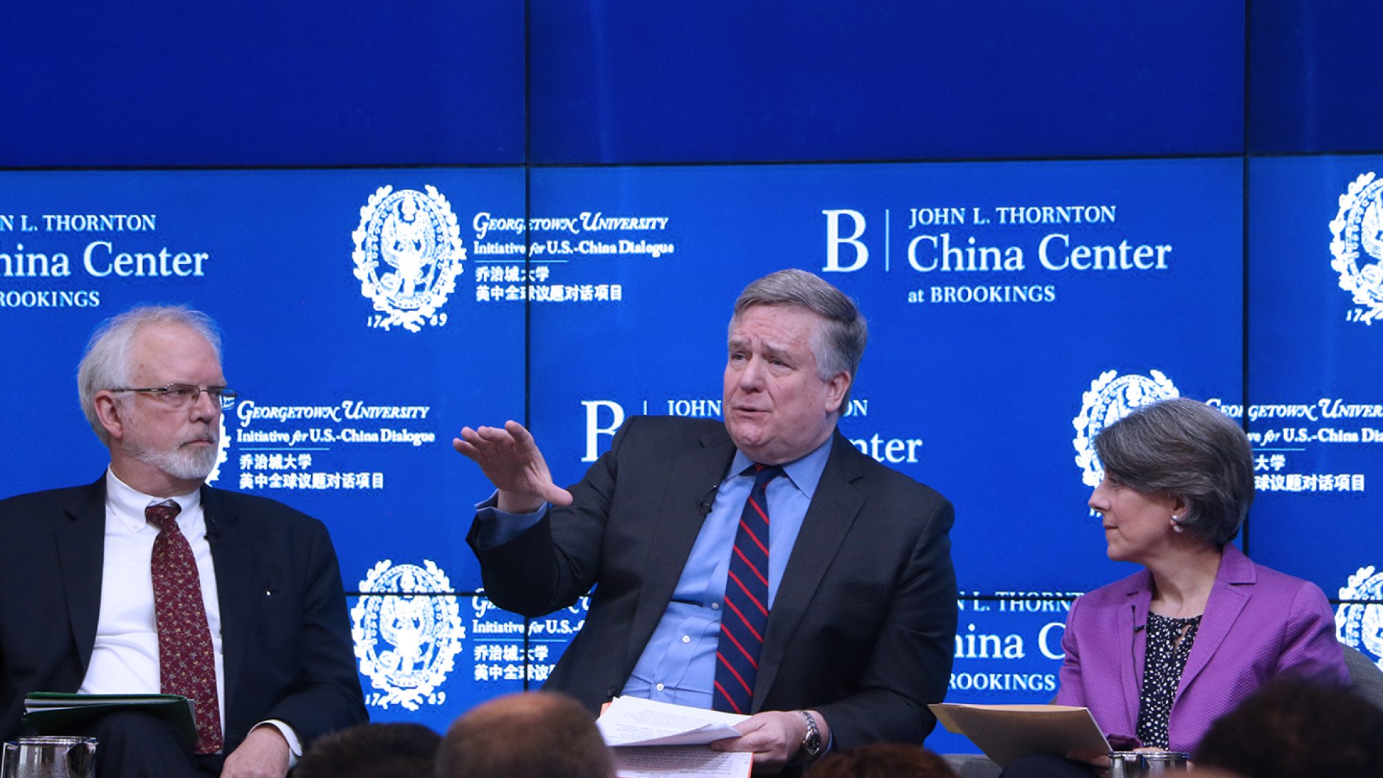 Professor Dennis Wilder, a former CIA China analyst, speaks on stage at an event.