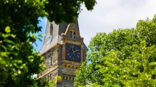 Healy Clock Tower, through trees.