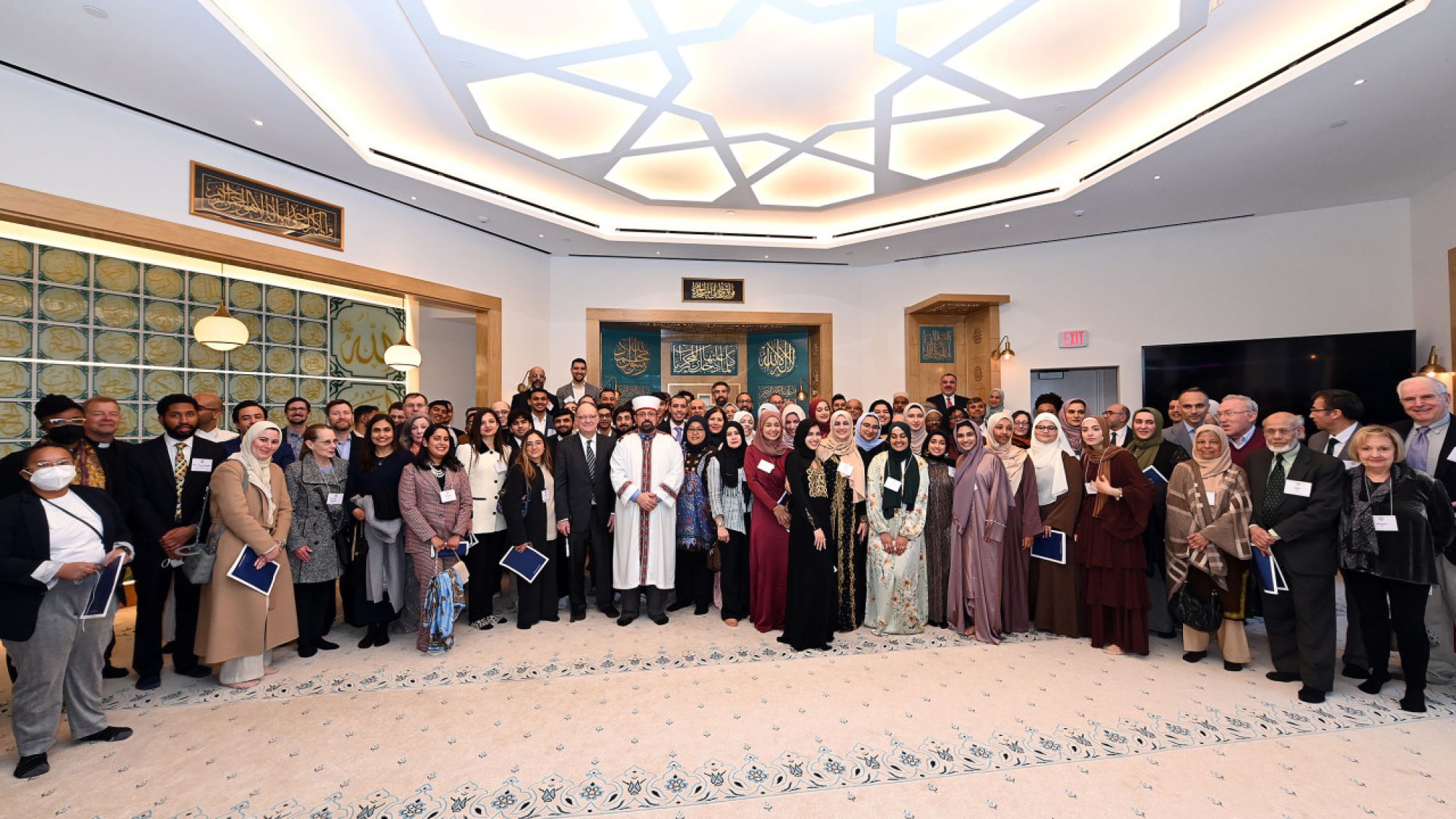 Students, alumni, Georgetown community members, Muslim leaders, a representative of the DC Council and diplomats from Turkey, Qatar and Indonesia pose for a photo at the March 18 event.