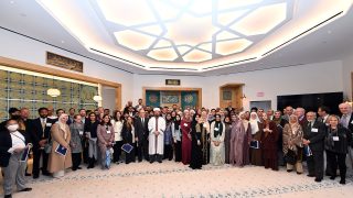 Students, alumni, Georgetown community members, Muslim leaders, a representative of the DC Council and diplomats from Turkey, Qatar and Indonesia pose for a photo at the March 18 event.