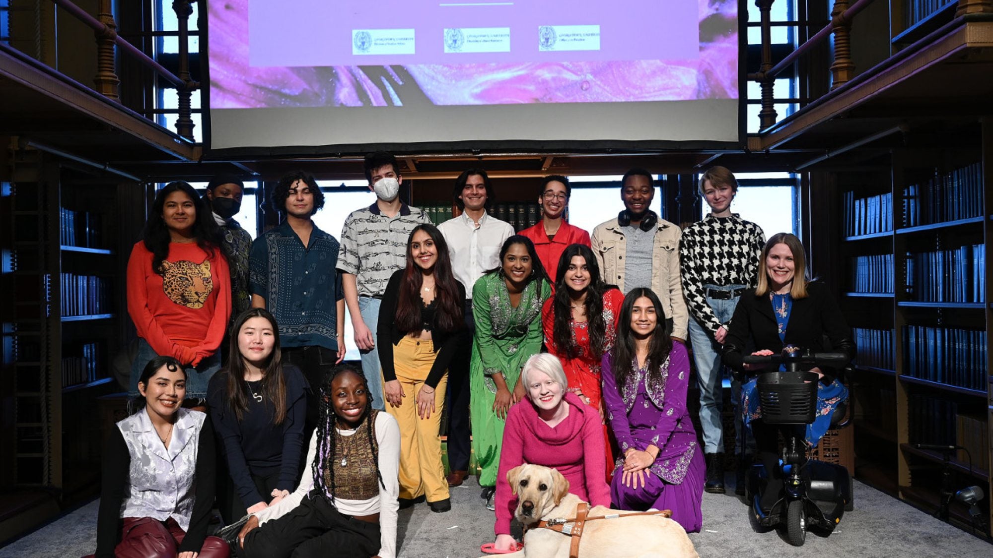 The event&#039;s student performers and Dr. Amy Kenny pose in Riggs Library