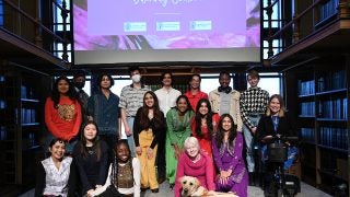 The event&#039;s student performers and Dr. Amy Kenny pose in Riggs Library